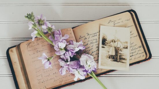 Photo of vintage book with a sepia photograph and flowers for blog post on RosaEmilia